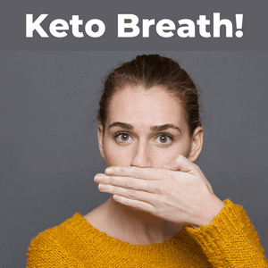 keto breath smell, woman covering mouth with bad breath on keto diet